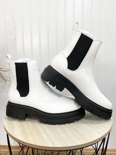 These boots are a chunky pull on boot and are black and white! These are such a cute fashion statement! The material is easy to wipe off and fun to wear everywhere! Trendy Chelsea Boots With Chunky Platform And High Ankle, Trendy High Ankle Chelsea Boots With Chunky Platform, Trendy Chelsea Boots With Chunky Platform, Trendy Chunky Platform Ankle Boots, Trendy Winter Chelsea Boots With Chunky Platform, White High Ankle Platform Boots For Fall, White High-top Boots With Thick Bottom, White Casual Chelsea Boots With Round Toe, Trendy White Martin Boots With Round Toe