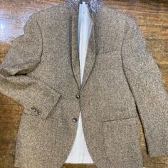 Tan Herringbone Fabric. This Is A Go To Piece. Easy To Wear And Matches With Everything. Two Button, Two Vents. Fully Lined. Pale Blue Lining With Red Trim. 50% Wool, 30% Poly, 20% Cotton. Inside Phone Pocket. Patch Pockets. Paisley Lining Under Collar. Beige Long Sleeve Tweed Jacket For Semi-formal Occasions, Brown Tweed Jacket With Single Button And Lapel Collar, Fitted Beige Sport Coat For Winter, Brown Tweed Jacket With Single Button, Brown Single Button Long Sleeve Tweed Jacket, Elegant Brown Single Button Tweed Jacket, Elegant Brown Single-button Tweed Jacket, Fitted Beige Tweed Jacket With Pockets, Semi-formal Beige Long Sleeve Tweed Jacket