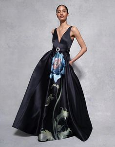 The Arabella Taffeta Gown is a design masterpiece, perfect for those opulent black-tie events. The large Japanese peony exudes a sense of dark romance, that tells a captivating visual story. The simplicity of the gown's silhouette is balanced by its dramatic sense of presence, and the beautifully designed back mirrors a deep-v front. The floral painting appears alive, gracefully trailing up the dress, making this piece a true show stopper. Cinched with a crystal buckle belt. 100% POLYESTER / LINING: 100% RECYCLED POLYESTER Japanese Peony, Taffeta Gown, Borgo De Nor, Visual Story, High Neck Sweater, Long Sleeve Sweater Dress, Black Tie Event, Buckle Belt, Floral Painting