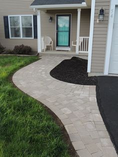 a brick walkway in front of a house