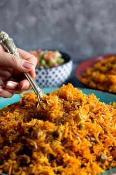 a person is spooning rice into a bowl