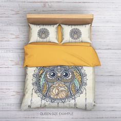 a bed with two pillows and an owl on it