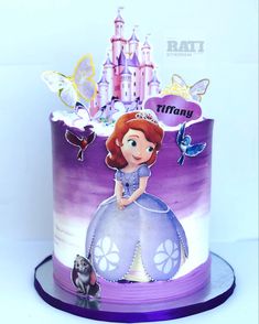 a purple and white cake with princess on top