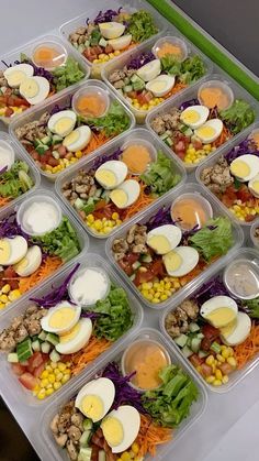 a plastic container filled with lots of different types of salads on top of each other