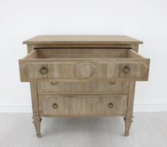 an old wooden dresser with two drawers on one side and a drawer on the other