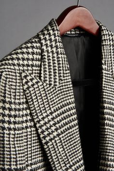 Our Prince of Wales coating fabric is a pure heavy duty wool woven in England. Weighing in at a beefy 19oz, this coat has a substantial hand and drape. Its key characteristic is the classic “prince of wales” (or “glenplaid”) pattern rendered in black and white yarns. This is a beautiful, timeless coat that makes a style statement but is also extremely versatile. Dress it up or dress it down, with everything from tuxedos to jeans. Every outfit will be a stunner with this coat. Thank us later. Timeless Long Wool Blazer, Timeless Wool Long Coat Blazer, Wool Houndstooth Outerwear For Office, Designer Wool Sport Coat For Winter, Houndstooth Pattern Long Coat For Business, Black Wool Blazer With Houndstooth Pattern, Elegant Wool Houndstooth Outerwear, Business Long Coat With Houndstooth Pattern, Business Houndstooth Pattern Long Coat