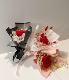 three different types of flowers on a white surface with one being red and the other is black