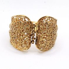 "DESCRIPTION: Step into the charm of the 1970s with this vintage gold-tone filigree bracelet. Crafted with meticulous attention to detail, the bracelet features intricate filigreed patterns adorning the entire piece. The centerpiece showcases a captivating butterfly accent, adding a whimsical touch to the design. In mint condition, this bracelet has been well-preserved over the years, maintaining its original allure. With a push-pull clasp for secure fastening, this bracelet measures 7 1/2\" in Vintage Yellow Gold Cuff Bracelet With Intricate Design, Gold Victorian Cuff Bracelet With Intricate Design, Formal Brass Bracelets With Intricate Design, Formal Brass Bracelet With Intricate Design, Gold Victorian Bangle With Intricate Design, Elegant Antique Gold Bangle, Vintage Gold Bangle With Intricate Design, Elegant Antique Gold Bracelet With Intricate Design, Vintage Adjustable Gold-plated Bracelet