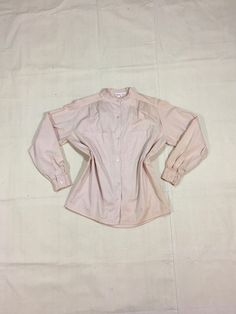 "1970s button up blouse pale clayish pink cotton long sleeve 2 front breast pockets button sleeve pleated cuff and upper front/back seam straight hem good vintage condition, w/wear light faded stains/sun/storage crease discoloration at sleeves/shoulders (see photos) please go by measurements, labeled M, see below measures, lying flat, shoulder-17\" chest-23\" sleeve-22 3/4\" length-27 1/2\"" Feminine Long Sleeve Cotton Shirt, Vintage Beige Blouse With Relaxed Fit, Vintage Long Sleeve Relaxed Fit Blouse, Vintage Long Sleeve Blouse With Relaxed Fit, Beige Vintage Blouse With Relaxed Fit, Beige Relaxed Fit Vintage Blouse, Feminine Cotton Shirt With Button Closure, Vintage Beige Shirt For Spring, Vintage Long Sleeve Tops With Button Cuffs