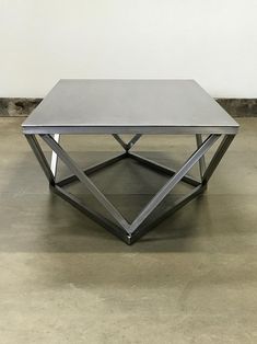 a metal table sitting on top of a cement floor