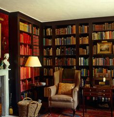 a living room filled with furniture and bookshelves covered in lots of bookcases