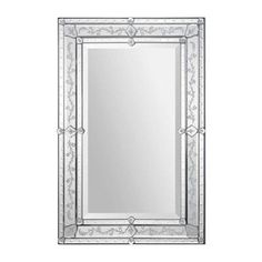 a large mirror with an ornate frame and silver trimmings on the bottom half