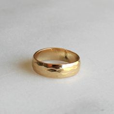 Thick Hammered Gold Band  Our thick hammered gold band ring is perfect for everyday! 14kt gold filled, this band is classic and timeless.  D E T A I L S -Hammered gold band - 5.5mm  -14kt gold filled  -snakeskin texture  D E T A I L S *Hammered gold band - 4mm *100% 14kt gold filled *Wear it plain or choose a special message for the inside CUSTOM HAND Engraving *Can be left blank or hand engraved *Inside is personalized in uppercase block letters or numbers *One character can be a heart or & sig Classic 14k Gold Filled Rings, Gold Hammered Thick Band Ring, Gold Hammered Wide Band Ring, Hammered Wide Band Rings For Everyday, Heirloom Style Wide Band 14k Gold Ring, Hammered Gold Ring In Recycled Material, Gold Hammered Ring In Recycled Gold, Hammered Gold Ring In Recycled Gold, Gold Hammered Ring Of Recycled Gold