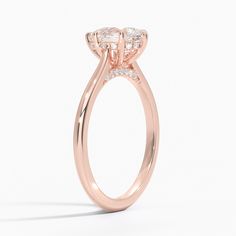 Pear Shaped Dawn Diamond Engagement Ring - 14K Rose Gold. This stunning ring features a petite band that sweeps up to embrace the gemstone in delicate claw prongs. Diamond accents adorn the gallery wire and bridge adding a unique touch to a classic look (1/10 total carat weight). Luxury 14k Rose Gold Halo Setting Rings, Luxury 14k Rose Gold Rings With Halo Setting, Elegant Emerald Cut Cluster Ring, Luxury 14k Rose Gold Cluster Ring, Luxury Rose Gold Round Cut Halo Ring, Rose Gold Asscher Cut Cubic Zirconia Diamond Ring, Timeless Rose Gold Ring With Lab Grown Diamond, Timeless Rose Gold Lab Grown Diamond Ring, Luxury Rose Gold Halo Ring