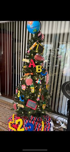 a small christmas tree decorated with magnets and letters