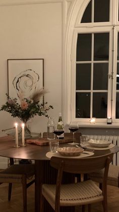 a dining room table with candles on it