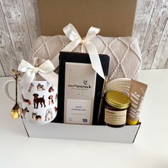 a gift box with coffee, cookies and other items in it sitting on a table