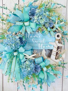 a wreath with blue flowers and an anchor