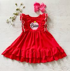 This listing is for the cutest red back to school dress!! Also Available in royal blue!! This is a cute ruffled red pinafore style dress. **This has a cute pink plaid VINYL apple with your choice of a personalized name or no name. You can also choose monogram initials.This is running true to size maybe slightly generous on top and hits to the knee or a little above. (See last picture for fit.) I think this could be paired with red ruffled shorties for a complete outfit or cute leggings. Last pic Fitted Ruffle Twirl Dress For Playdate, Fitted Twirl Dress With Ruffles For Playdate, Cute Short Sleeve Twirl Dress With Ruffles, Cute Ruffled Short Sleeve Twirl Dress, Cute Spring Dress For School, Cute Pink Twirl Dress With Flutter Sleeves, Cute School Dress For Spring, Playful Fitted Dress For School, Casual Ruffled Dresses For School