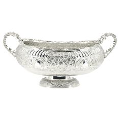 an ornate silver bowl on a stand