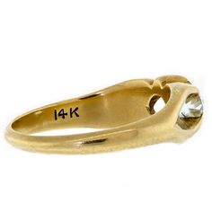 an 18k yellow gold ring with a diamond