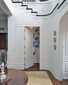 an entry way leading to a foyer with white walls and wood flooring on the other side