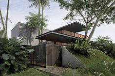 the house is surrounded by lush vegetation and trees