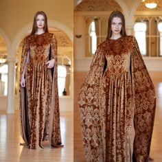 a woman in a brown dress with long sleeves and a large cape on her head