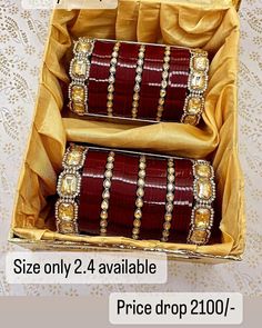 two red and gold bracelets in a box on a white tablecloth with the text, size only 2 4 available price drop 2010