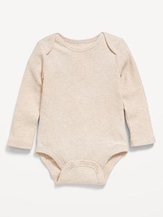 a baby bodysuit with long sleeves and buttons on the chest, in light beige