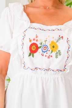 This top is pure perfection! Expertly crafted with a ruffle design and delicate embroidery detail, this top exudes femininity and charm! The babydoll design adds a playful touch to this versatile top! Self- 100% Polyester Lining- 100% Rayon White Ruffled Peasant Top For Brunch, White Feminine Peasant Top With Ruffles, White Ruffled Cotton Peasant Top, White Bohemian Top With Ruffles, White Cotton Peasant Top With Ruffles, Flowy Embroidered White Tops, Cute White Blouse With Floral Embroidery, Flowy White Embroidered Top, Spring Cotton Peasant Top With Ruffles