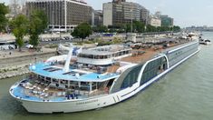 a large white boat floating on top of a river