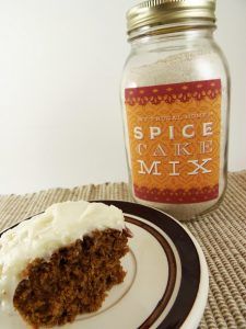 a piece of cake on a plate next to a jar of spice