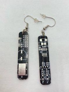 "TechWears Black&Silver Circuit Board Earrings are known to make people smile and spark conversation. Each unique pair is handmade from the most beautiful recycled circuit boards we can find.  P R O D U C T  I N F O R M A T I O N  * Circuit Board Dimension: 1 3/4\" x 5/16\" * Total Length: 2  5/8\" * Weight: 1.5 Grams Each * Nickle Free Silver Plated Earwire  * Upcycled Circuit Board F A B R I C A T I O N * All designs are made from 100% pre- or post-consumer recycled circuit boards * Recycled circuit boards are cut, sanded and cleaned under strict safety standards.  * All items are handmade in Colorado Springs, CO USA N O T E S  O N  M A T E R I A L S  * Variations in pattern and color should be expected as each item is made from a different circuit board. Unless specifically stated, the Circuit Jewelry, Circuit Earrings, Earrings Dangling, People Smile, Circuit Board, Black And Silver, Colorado Springs, Rectangle Shape, True Beauty