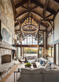 a living room filled with lots of furniture and a fire place in the middle of it