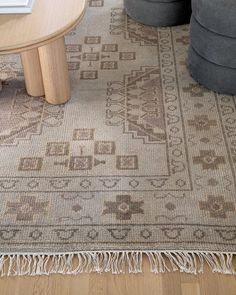 a living room area with a rug, chair and coffee table