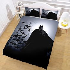 a bed with batman silhouettes and bats on it