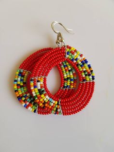 This listing is for ALL 11 pairs like shown above. The earrings are 100% handmade using original fine beads. Colorful and bright colors. ^^These earrings ships through dhl express. More earrings; https://www.etsy.com/shop/TribalTess?ref=seller-platform-mcnav&section_id=21293980 Buy multiple items and pay shipping for ONE item ONLY. Traditional Multicolor Beaded Hoop Earrings, Traditional Multicolor Beaded Earrings, Traditional Round Beaded Earrings With Large Beads, Multicolor Hoop Earrings With Large Beads As Gift, Colorful Round Beaded Earrings, Multicolor Dangling Round Beads, Multicolor Round Dangling Beads, Traditional Red Beaded Earrings With Colorful Beads, Traditional Handmade Red Hoop Earrings