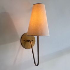 a wall light with a white shade on it