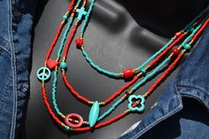 "This fun little number is composed of red, turquoise and gold seed beads and precious stones and various mixed media like howlite, coral, and glass beads that are set asymmetricaly set within its four strands.  It is a very unique piece that is fun and versatile and sure to delight!  *Gold filled lobster clasp and findings. Necklace measures approximately 18\" (at shortest strand)." Hippie Red Round Bead Jewelry, Hippie Style Red Jewelry With Colorful Beads, Red Hippie Jewelry With Colorful Beads, Handmade Red Hippie Beaded Necklace, Red Beaded Hippie Necklace, Bohemian Red Gemstone Beads, Bohemian Red Beads For Beach, Red Gemstone Beaded Bohemian Necklace, Red Bohemian Beaded Necklaces With Gemstone Beads