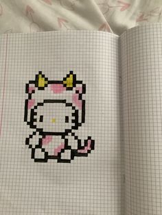 an open book with a drawing of a hello kitty in it's face on the page