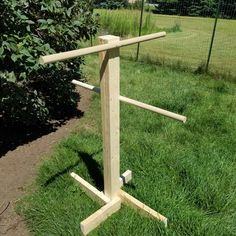 a wooden rack stands in the grass