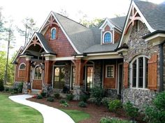 this is an image of a house with stone and wood trimmings on the front