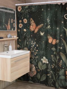 a bathroom with a shower curtain that has butterflies on it and flowers in the background