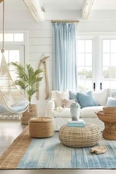 a living room filled with lots of furniture and decor on top of a wooden floor