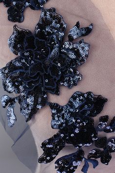 black and silver sequins on fabric with scissors