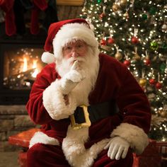 a santa clause sitting in front of a christmas tree with the words 22 days till christmas