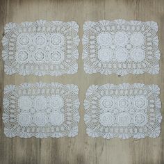 four white doily sitting on top of a wooden table