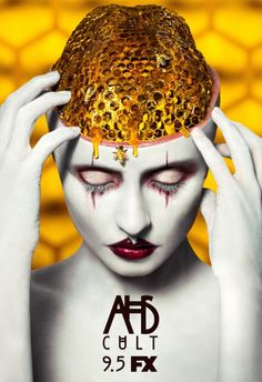 a woman with white makeup holding her head covered in honeycombs and dripping yellow liquid