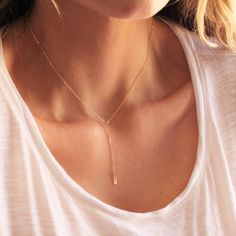 "Our dainty lariat necklace is stylish and minimalist. This dainty necklace is perfect with your favorite tee or your little black dress. A tiny bar adorns a silver or gold chain.  D E T A I L S *Dainty 12mm bar  *Hammered by hand  *2 inch drop  *Dainty link chain *100% 14kt gold-filled or sterling silver LENGTH *The standard length is normally 18\". *Model is wearing a 16\" in Photos. HOW TO PERSONALIZE *Select your choices from the drop down menu to create your custom design. ∙ EXTRA LOVE ∙ Ha Adjustable Dainty Rose Gold Lariat Necklace, Adjustable Rose Gold Dainty Lariat Necklace, Dainty Adjustable Rose Gold Lariat Necklace, Delicate Rose Gold Lariat Necklace Gift, Dainty Rose Gold Lariat Necklace, Delicate Rose Gold Lariat Necklace With Clavicle Chain, Minimalist Adjustable Lariat Necklace With Clavicle Chain, Adjustable Minimalist Rose Gold Lariat Necklace, Delicate Rose Gold Lariat Necklace